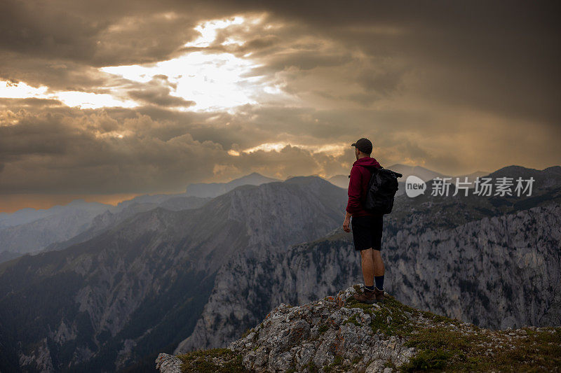 Male hiker enjoying beautiful view from mountain top. Aflenzer Bürgeralm